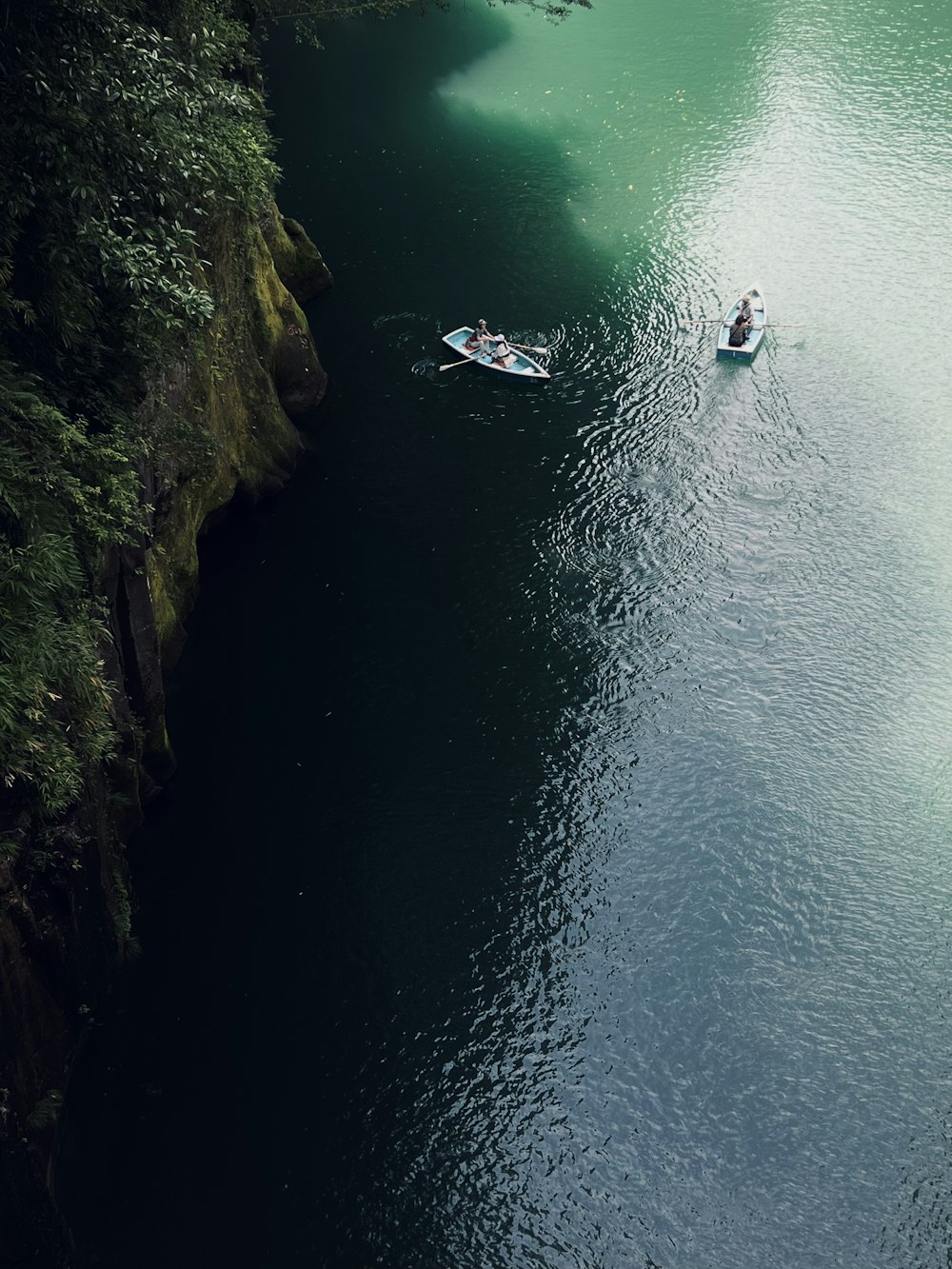 a couple of boats floating on top of a river