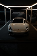 A sleek car spinning in a digital showroom with zoomed-in views of the interior and dashboard.