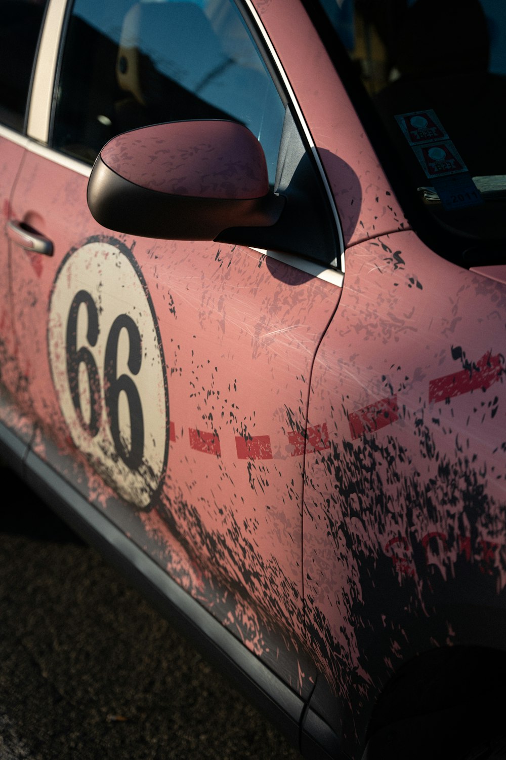 a pink car with a number 66 painted on it