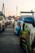 A group of legends cars lined up on the starting grid under a bright Finnish sky.