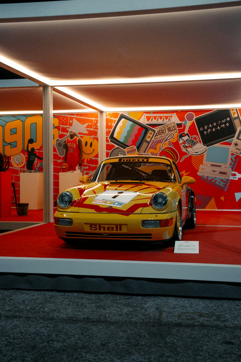 a yellow sports car on display in a store window