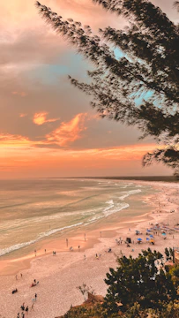 A vibrant photo of travelers enjoying a scenic Batam beach at sunset.