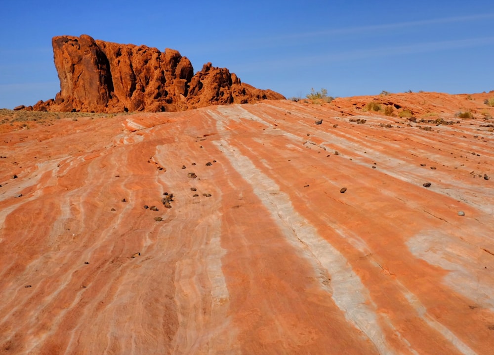 a large rock outcropping in the middle of a desert