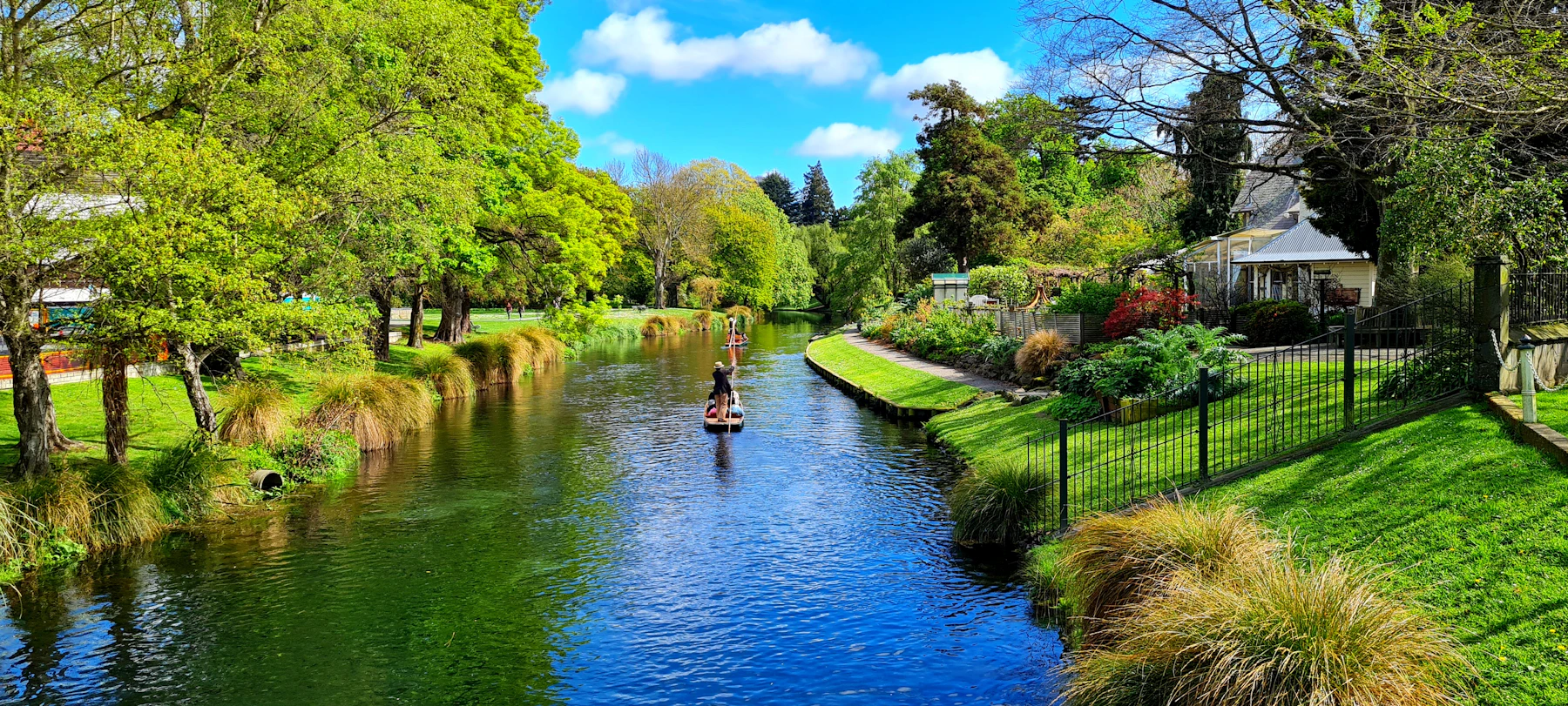 The Ōtākaro Avon River flowing through a green Christchurch park