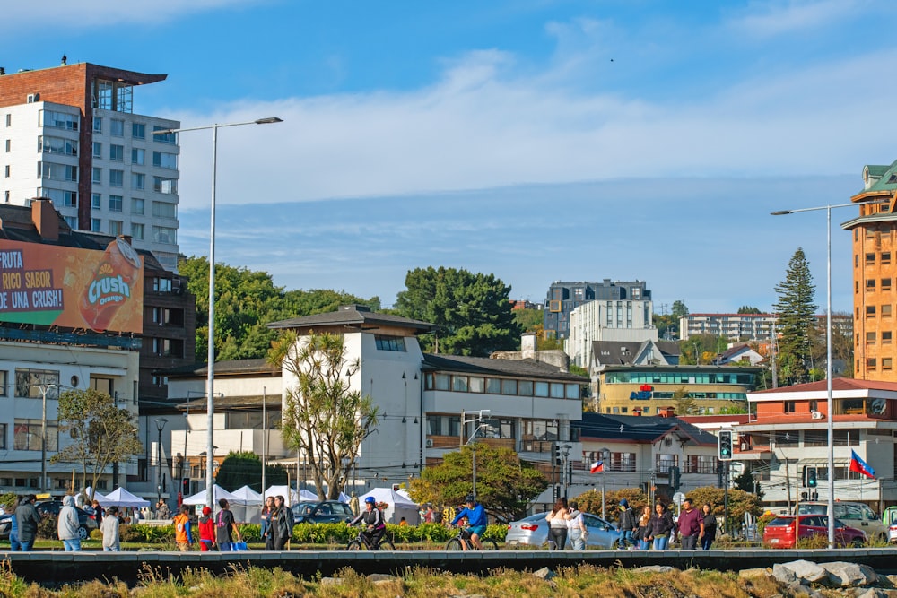 a group of people standing on the side of a river