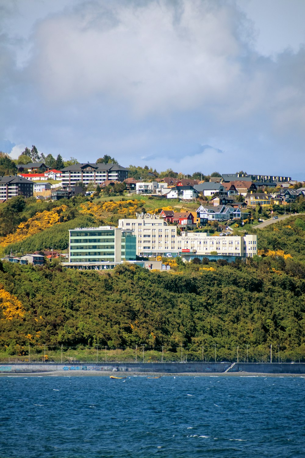 a large building sitting on top of a lush green hillside