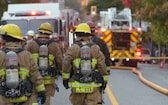 a group of firefighters walking down a street