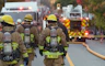 a group of firefighters walking down a street