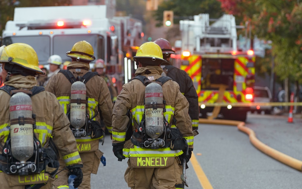 a group of firefighters walking down a street