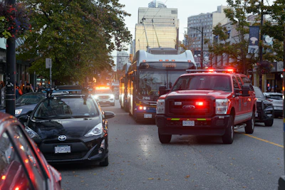 Close-up of a car crash scene on a busy New York street with emergency responders.