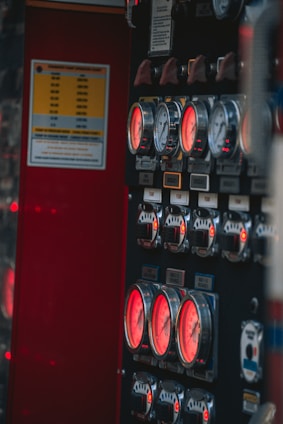Close-up of a modern fire alarm control panel with glowing indicators.