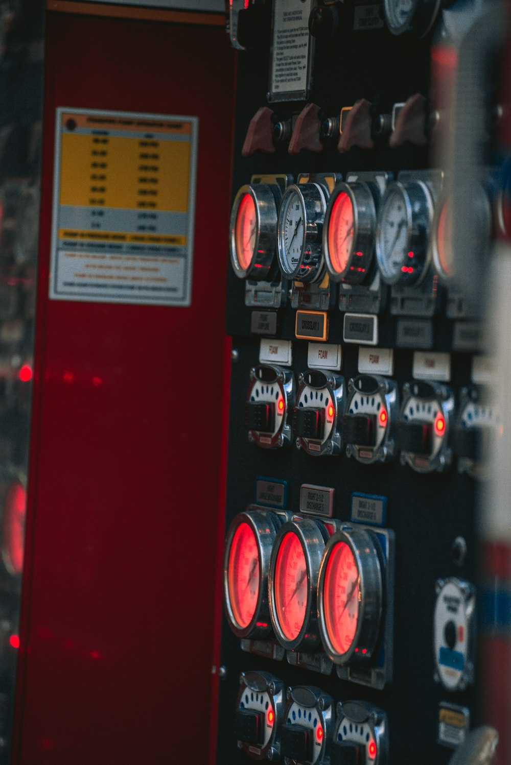 a close up of a red and black control panel