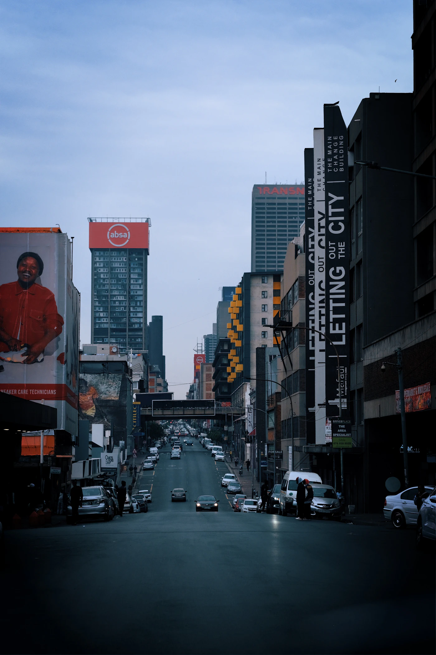 Outdoor advertising on buildings along a busy Johannesburg city street