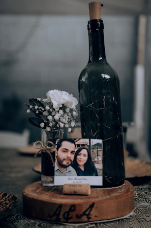 Couple proudly holding their personalized wine bottles prepared for a wedding.