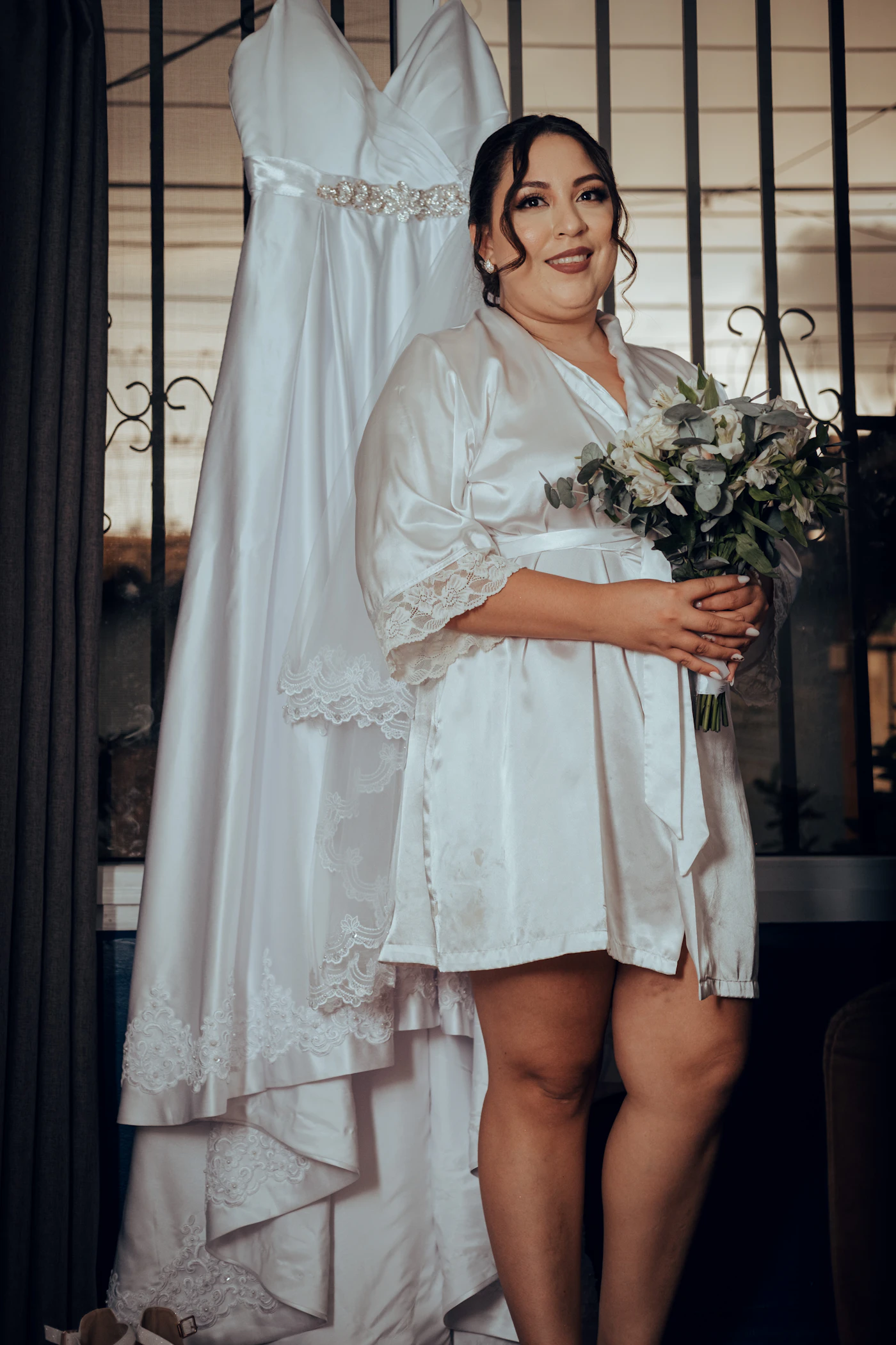 Affordable plus-size bridal gowns under $1,500 — A happy plus-size bride smiling in a beautiful wedding gown.