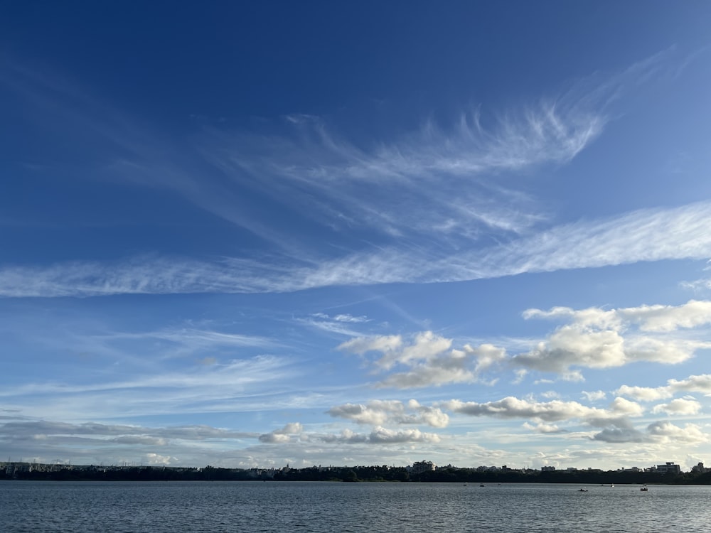 a large body of water with clouds in the sky