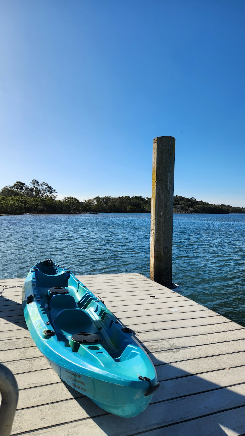 a blue kayak sitting on top of a wooden dock
