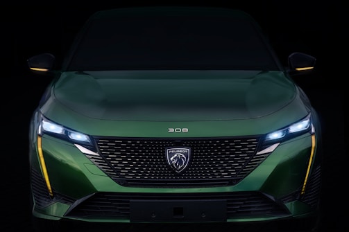 Side profile of a Peugeot car showing its clean lines and shiny finish.