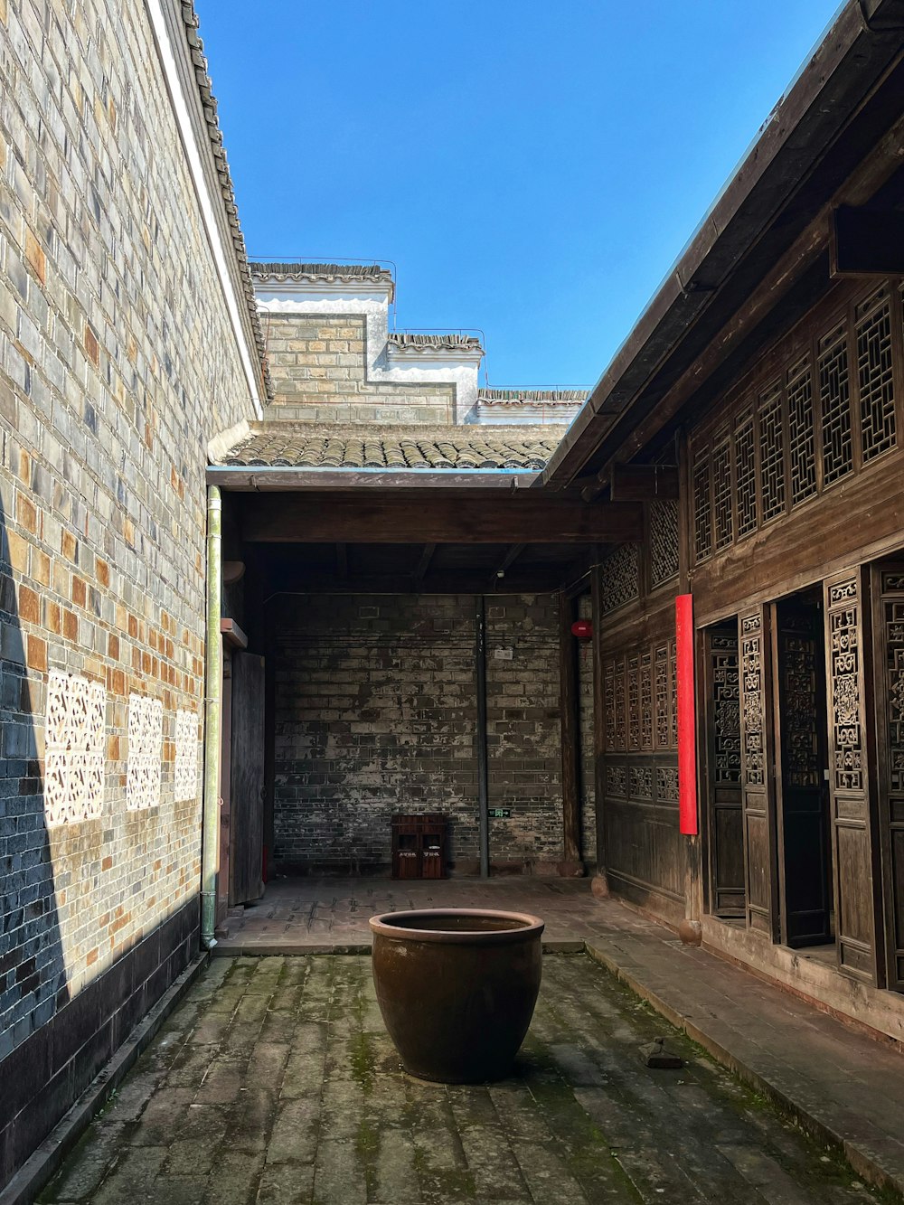 a courtyard with a large pot on the ground