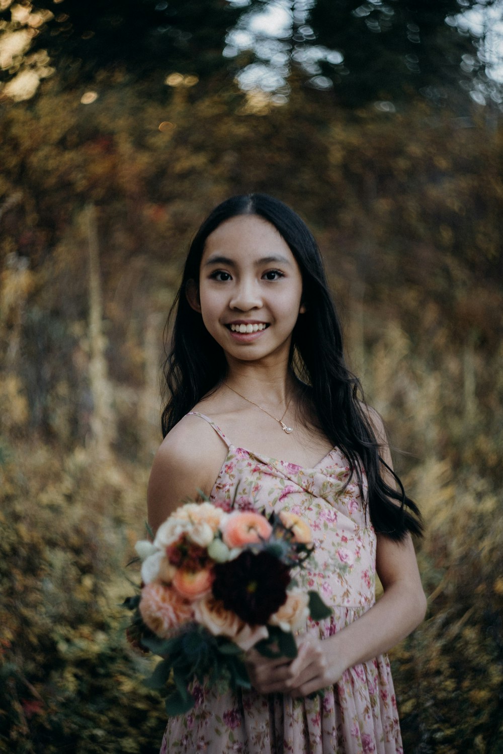 a woman in a dress holding a bouquet of flowers