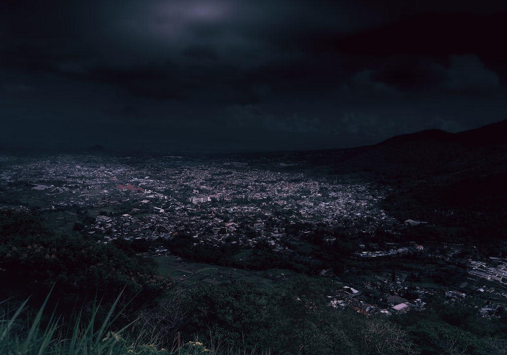 a view of a city from a hill at night