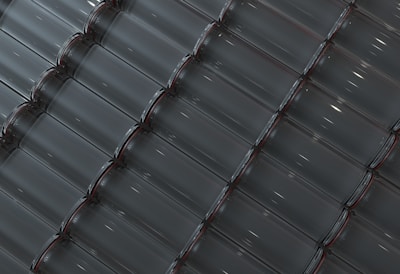 A bright and clean factory floor with rows of glass bottle production lines in action.