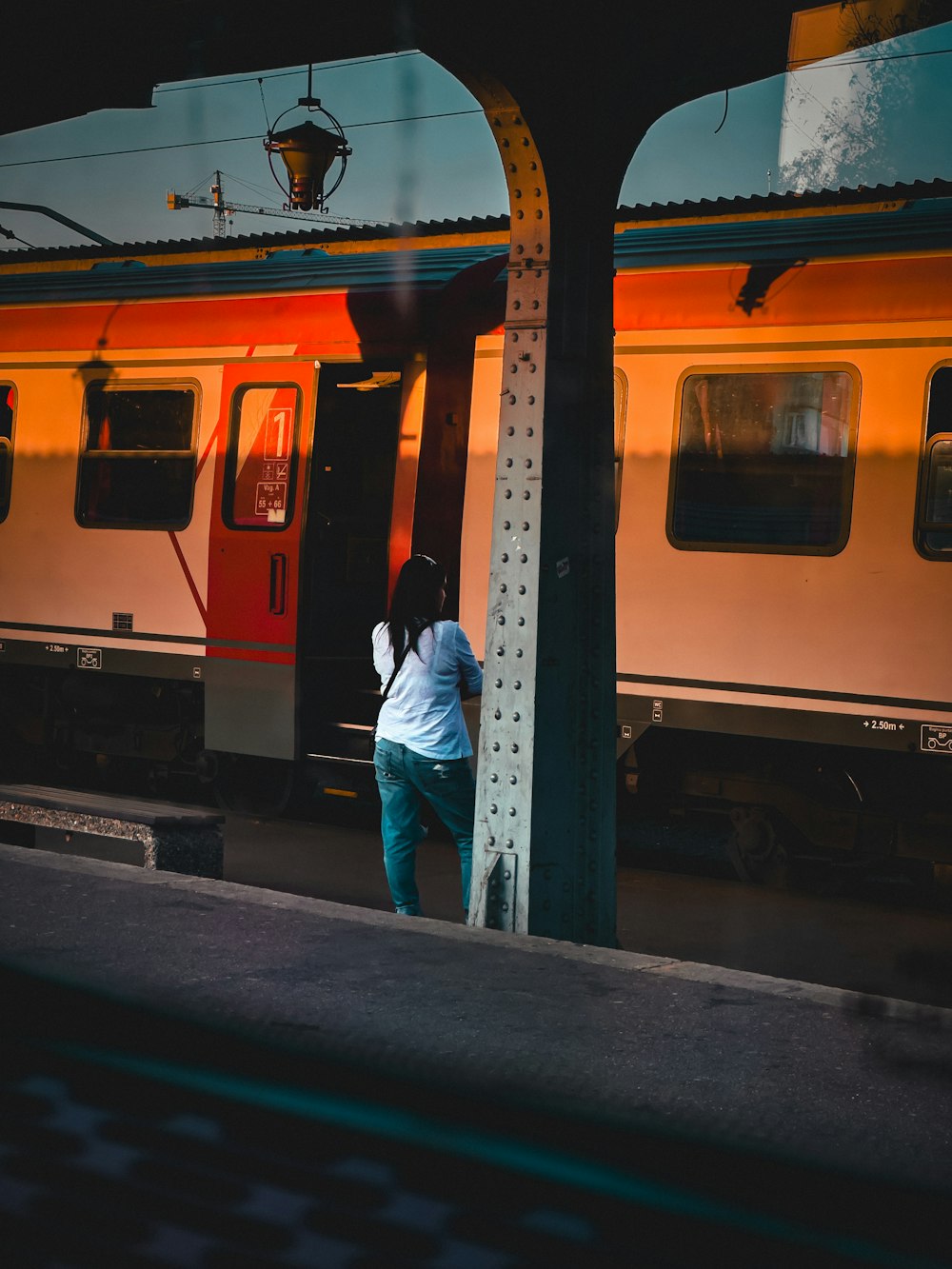 a person standing on a platform next to a train