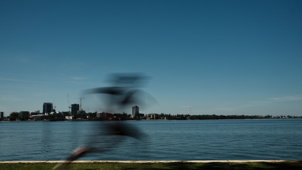 a blurry photo of a body of water with a city in the background