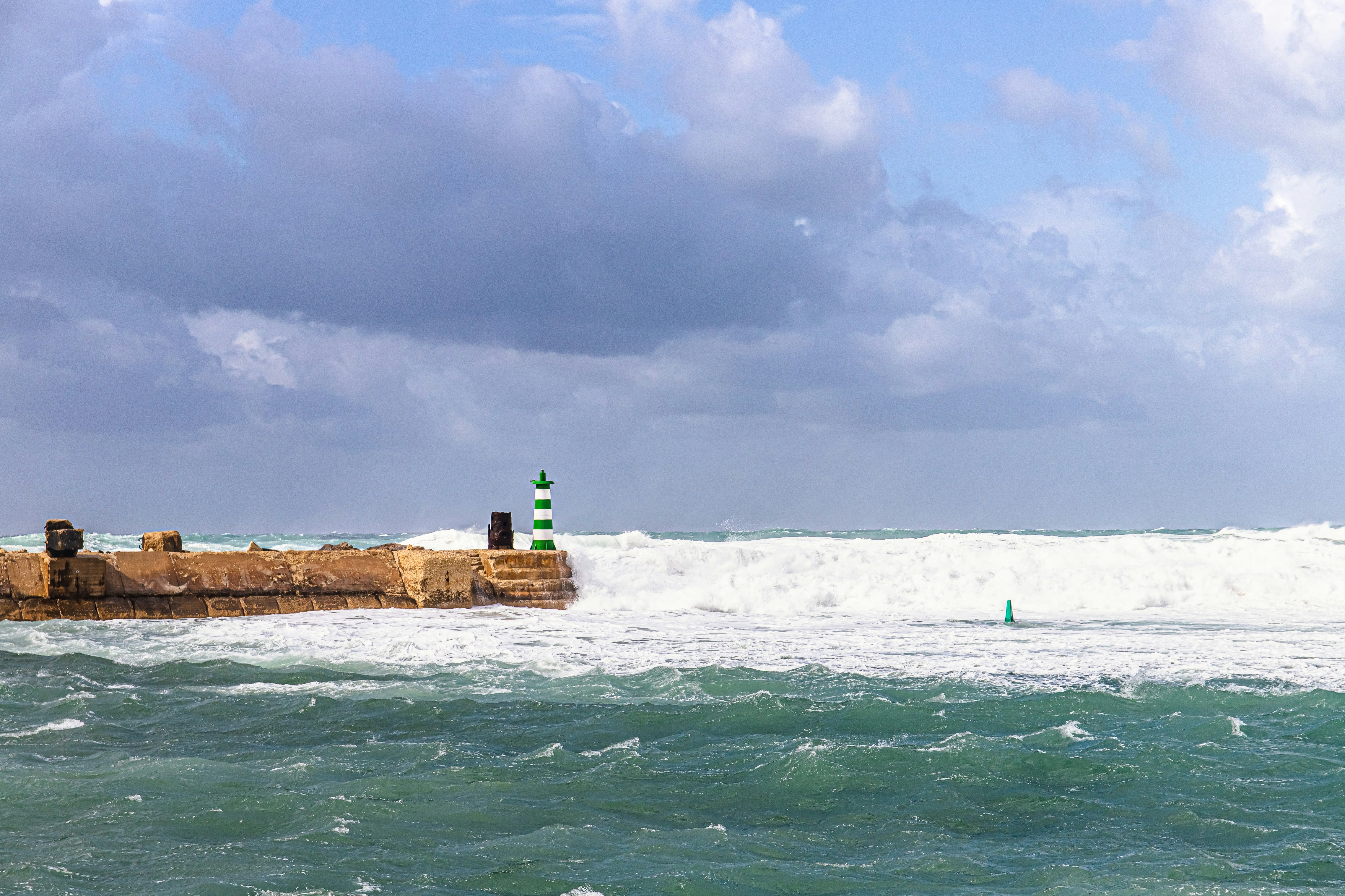 a large body of water with a lighthouse in the middle of it