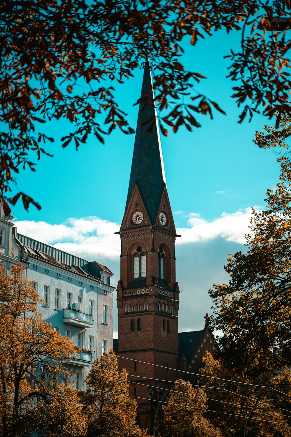 a tall clock tower with a clock on each of it's sides