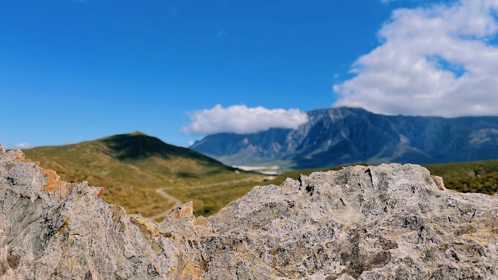 a view of a mountain range from a rocky outcropping