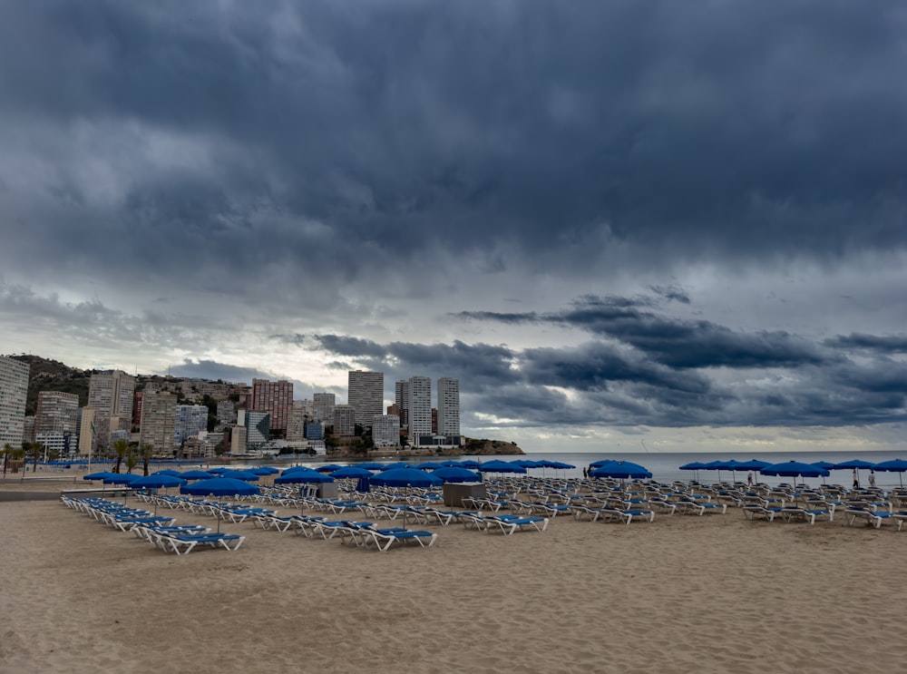 a bunch of chairs and umbrellas on a beach