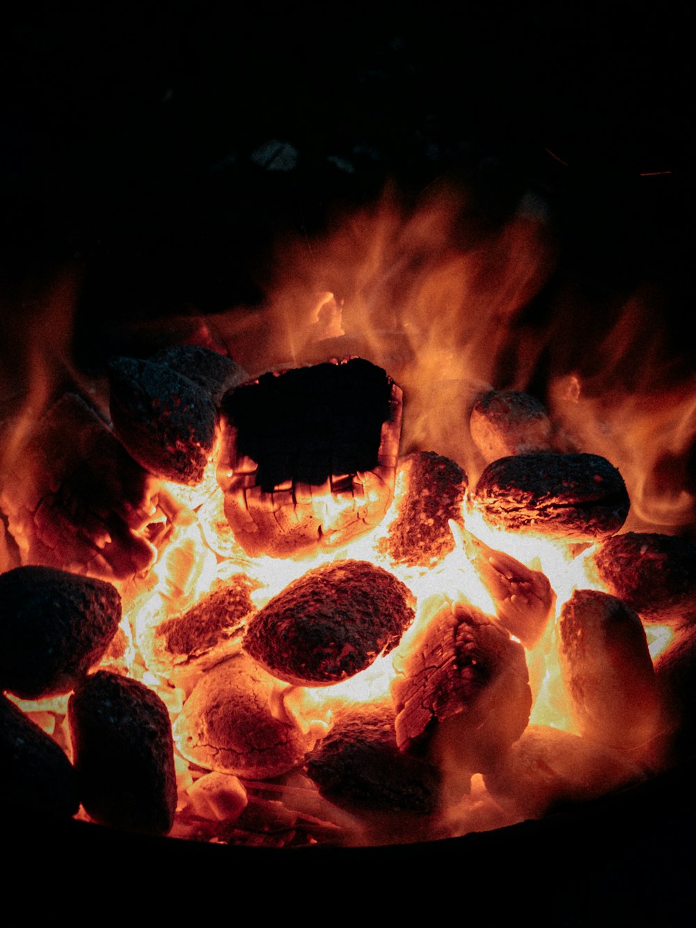 a close up of a fire with rocks in it