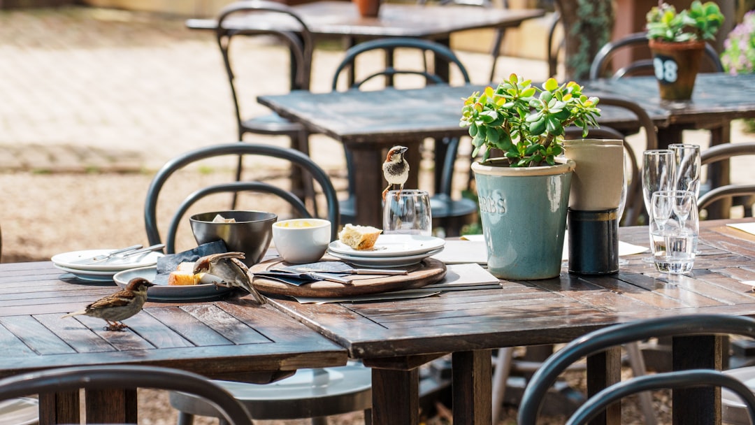 a wooden table topped with plates of food,