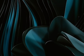Abstract curved shapes with a sleek, glossy texture in shades of dark teal and black. The flowing lines create a sense of motion and depth, offering a sophisticated, modern aesthetic.