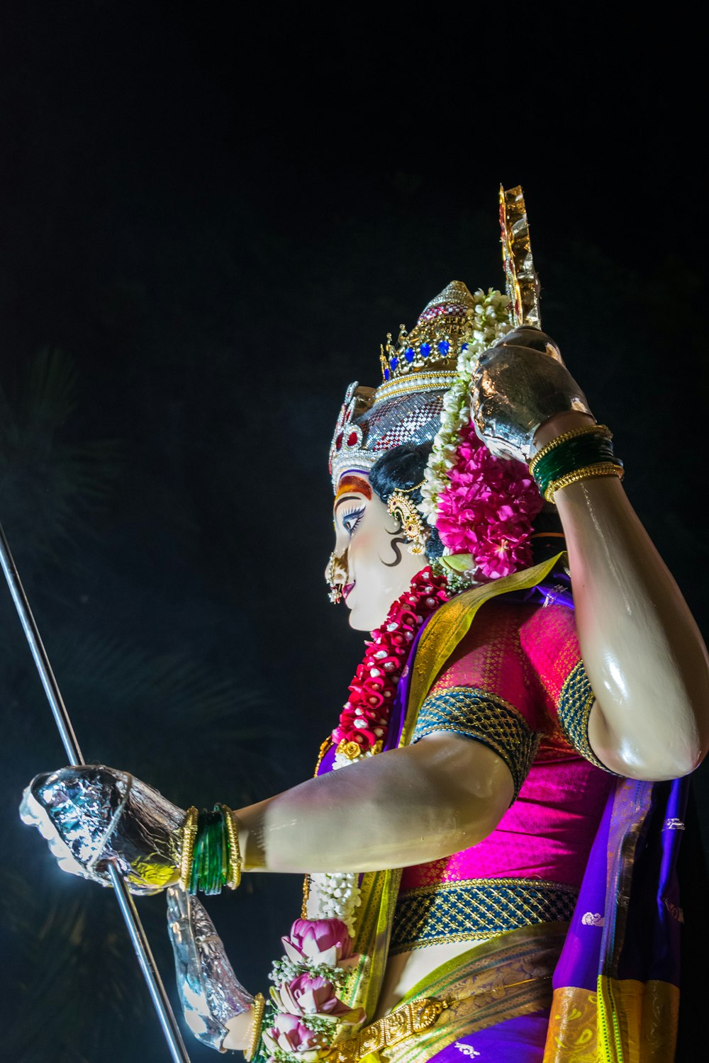 a statue of a woman holding a stick