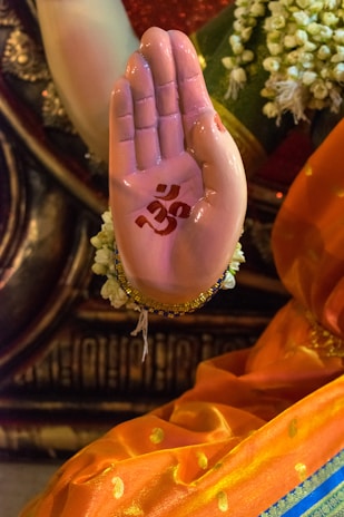 Hands raised with intricate signs as part of a church ritual.