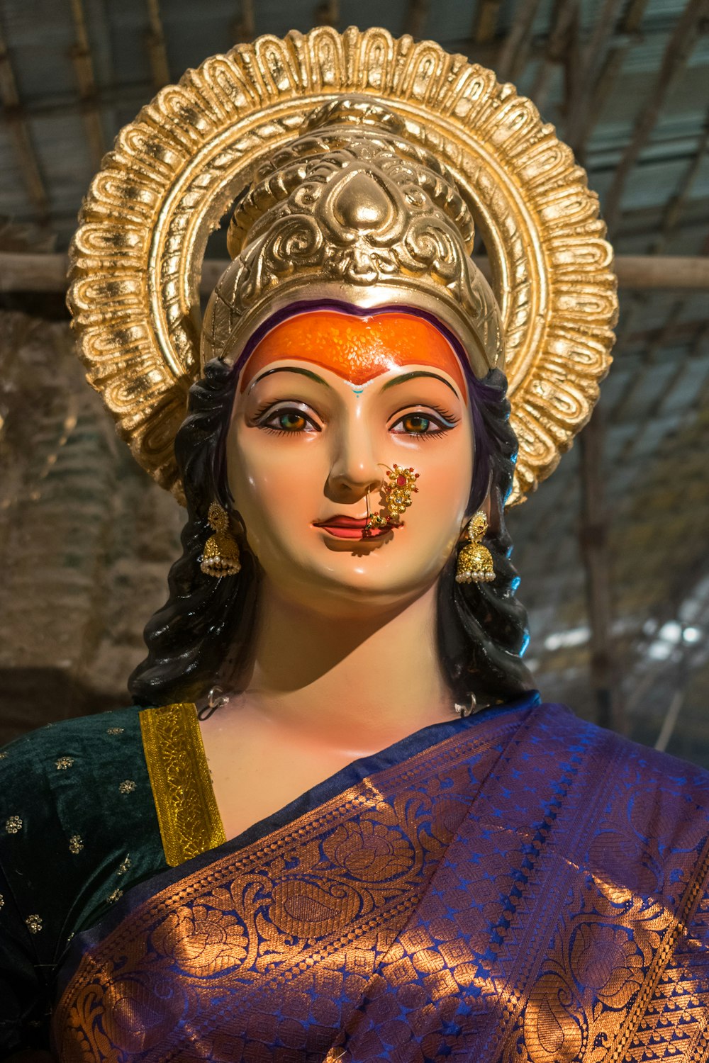 a close up of a statue of a woman wearing a headdress