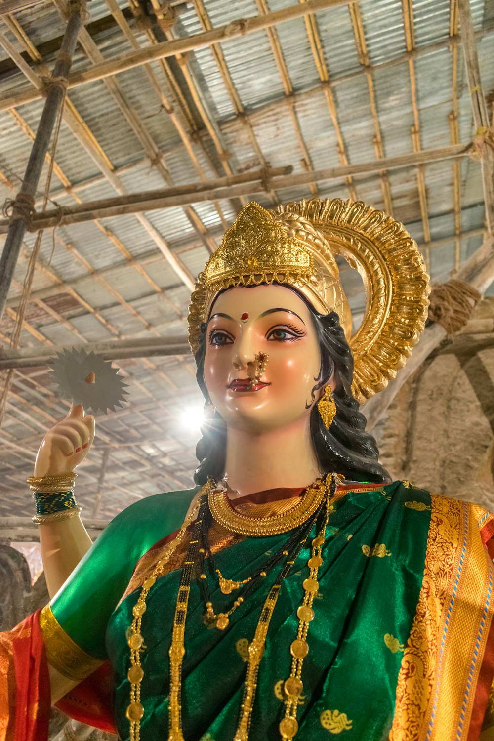 a statue of a woman in a green and gold outfit