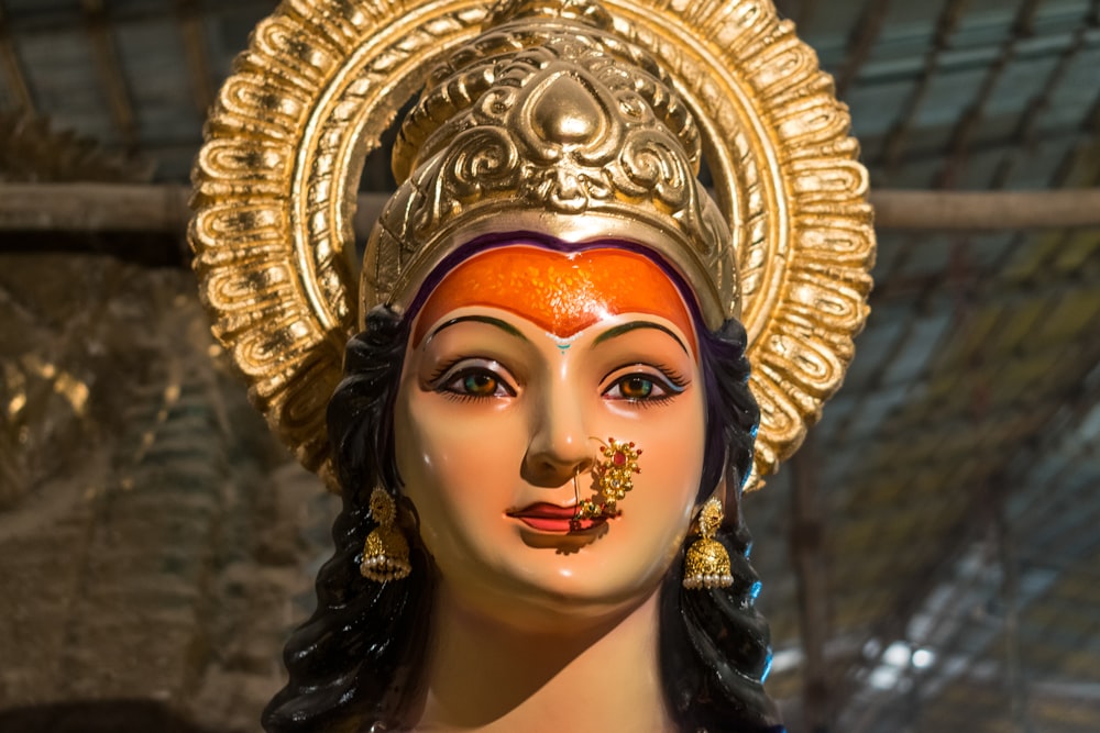 a close up of a statue of a person wearing a headdress