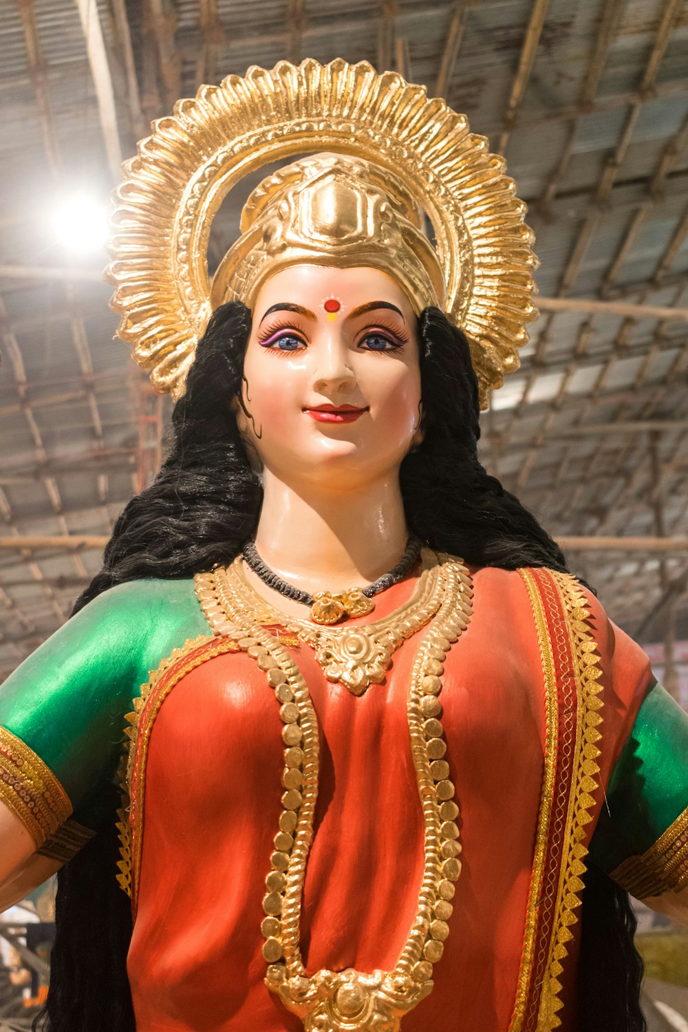 a statue of a woman in a red and green outfit