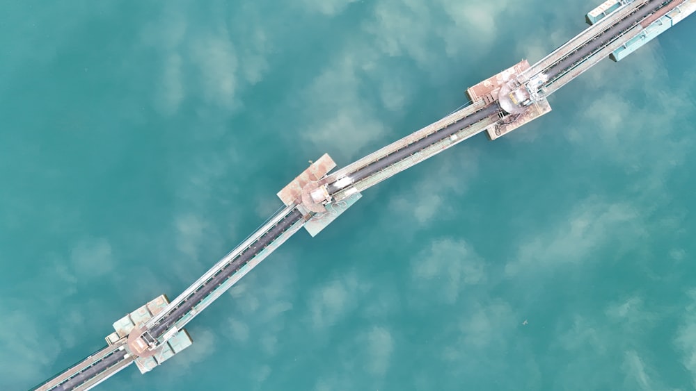 an aerial view of a bridge over a body of water