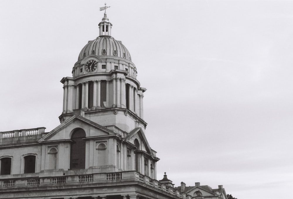 a black and white photo of a building with a clock tower