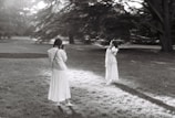A professional photographer capturing a couple in a park.