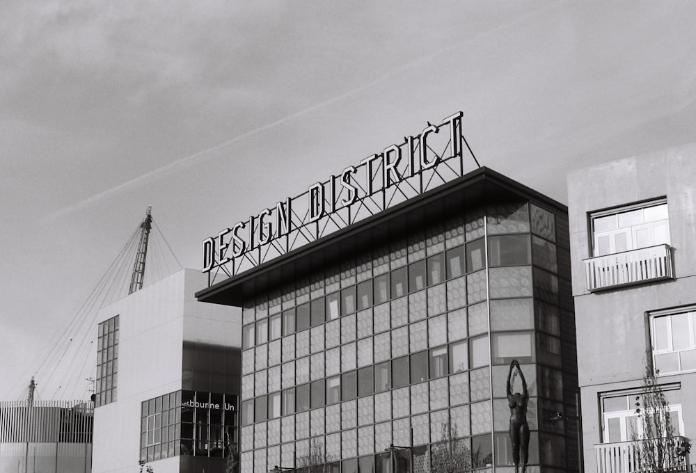 a black and white photo of a building with a sign on top