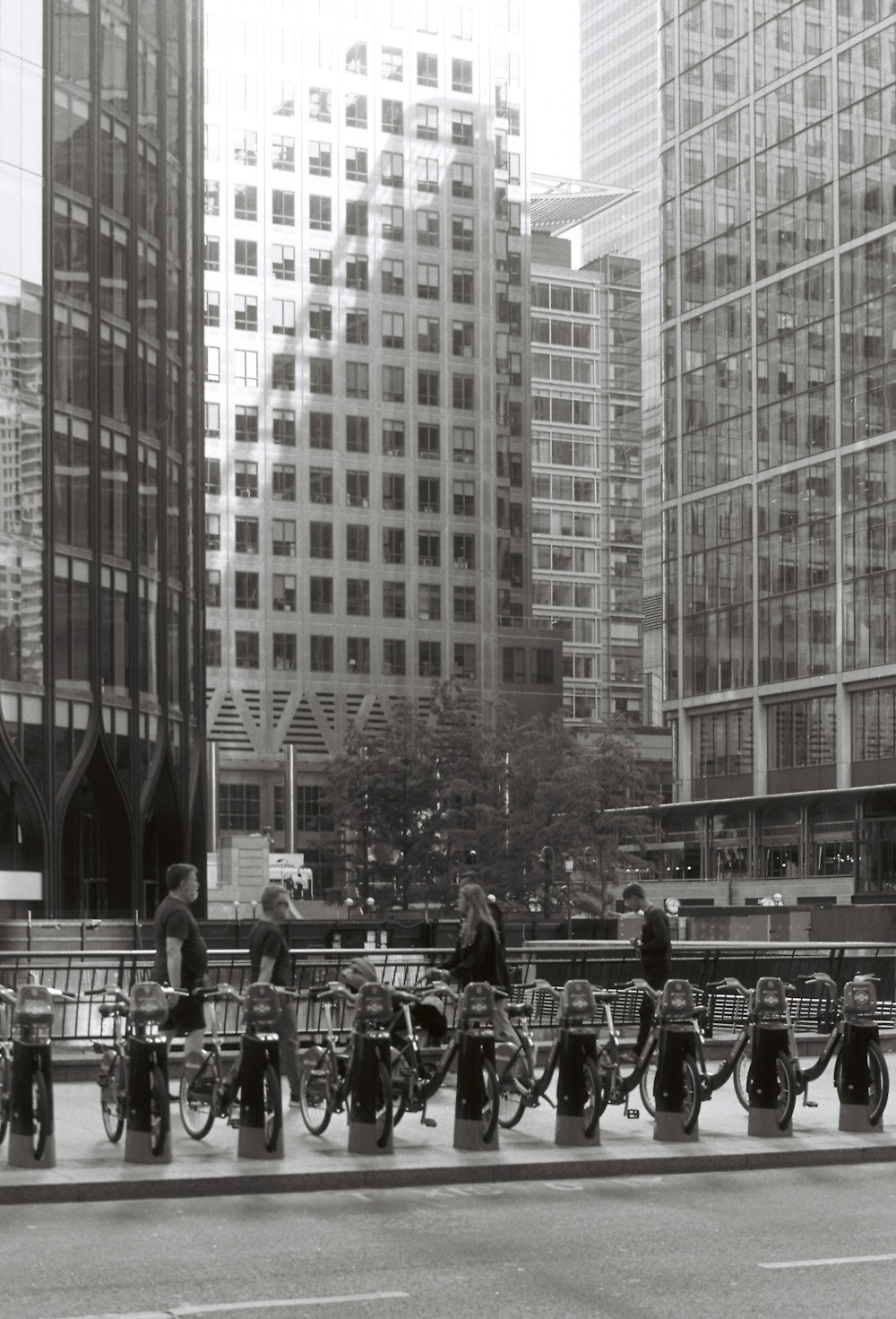 a black and white photo of people on bicycles