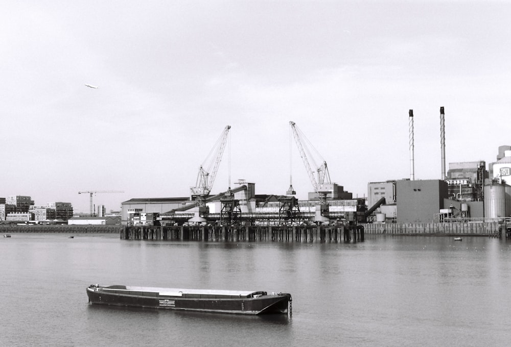 a boat floating on top of a river next to a dock