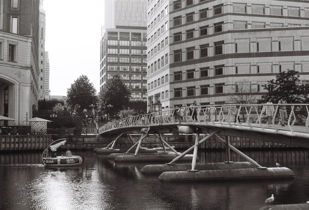 a boat traveling down a river next to tall buildings