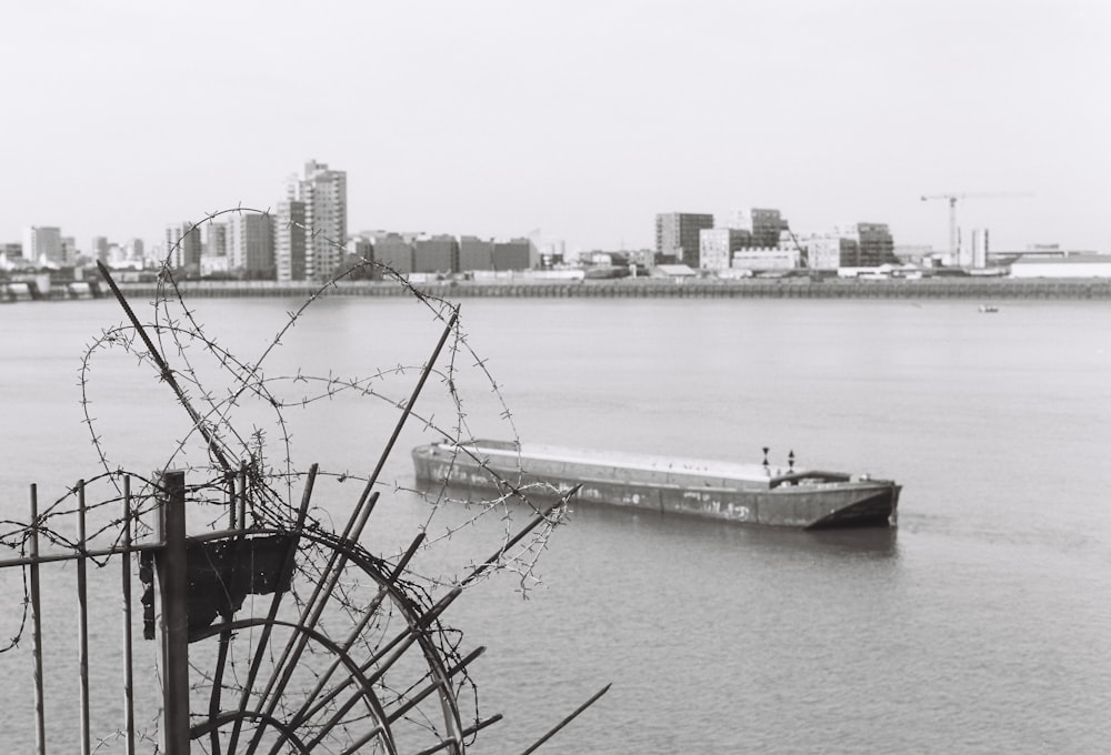 a boat in a body of water with a city in the background