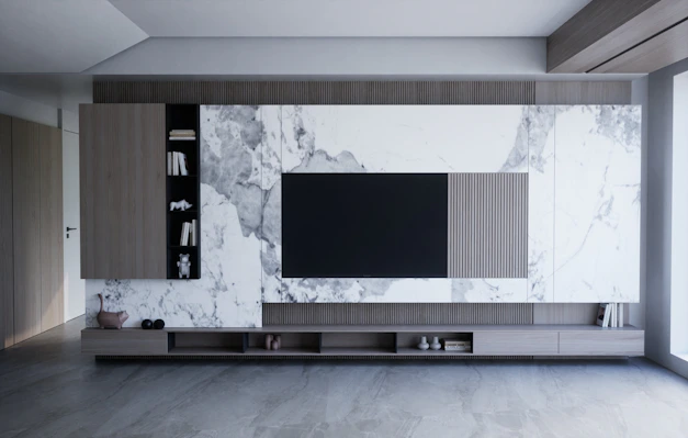 a living room with a large tv on the wall